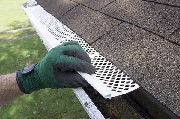 gutter guards significantly reduce the need for gutter maintenance by preventing debris buildup